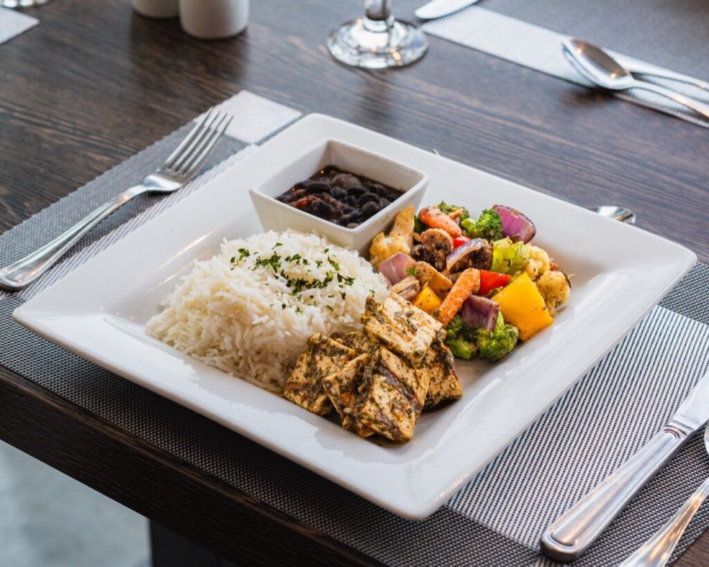 A lunch plate of rice, black beans and roasted vegetables at The Ivy Steakhouse
