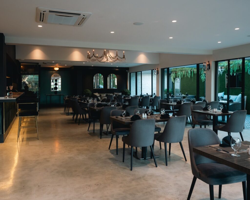 The Ivy dining room with the bar along one side and tables set for service