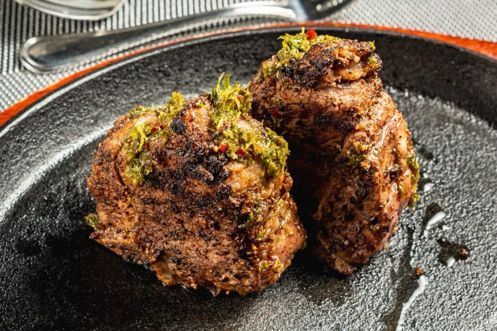 The Ivy signature lamb porterhouse, served on a cast-iron skillet