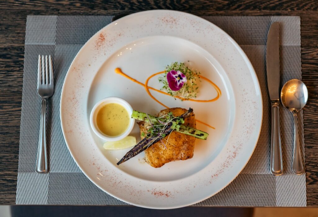 Zesty sea bass with caramelized fennel and citrus butter at The Ivy Steakhouse